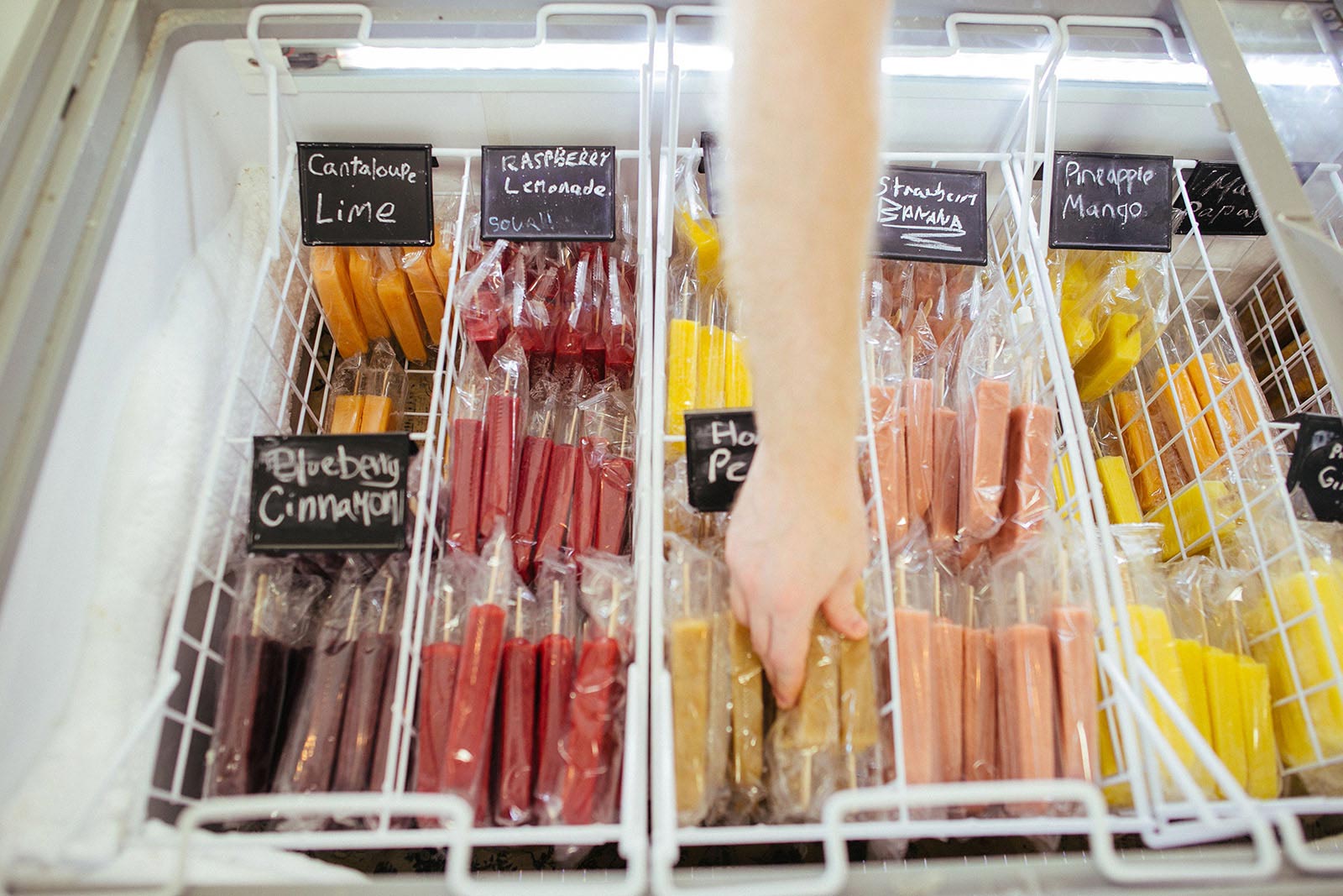 arm reaching in cooler for popsicle 
