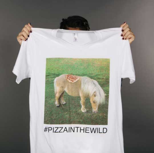 girl holding shirt with donkey image