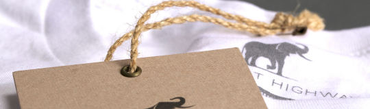 hang tag sitting on white shirt